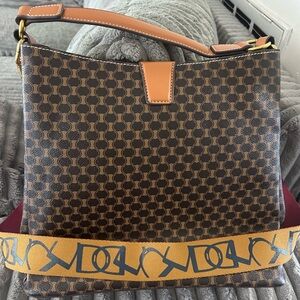 Brown Patterned Shoulder Bag with Tan Trim and Decorative Strap